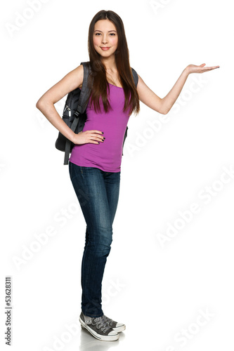 Photo: Casual girl wearing backpack showing copy space on palm Casual girl wearing backpack showing copy space on palm