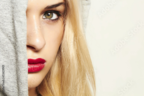 Photo: beautiful blond woman in hood. red lips. text here beautiful blond woman in hood. red lips. text here