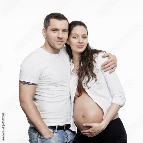 Photo: Pregnant couple isolated on white background Pregnant couple isolated on white background