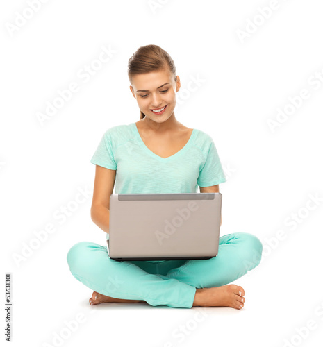 Photo: young girl sitting on the floor with laptop young girl sitting on the floor with laptop