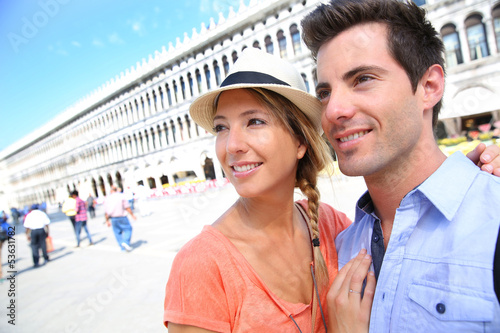 Photo: Couple of tourists in San Marco place in Venice Couple of tourists in San Marco place in Venice