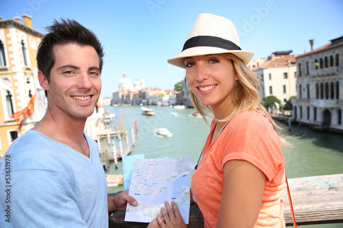 Photo: Couplelooking at map on the Academia Bridge in Venice, Italy Couplelooking at map on the Academia Bridge in Venice, Italy