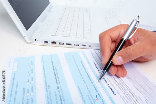 Photo: Businessman filling the form. Businessman filling the form.