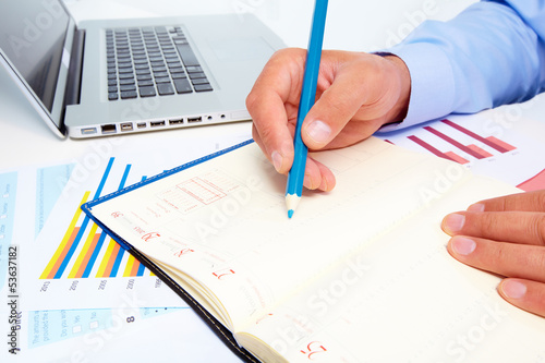 Photo: Businessman working with documents. Businessman working with documents.