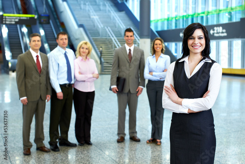 Photo: Business woman and a group of workers. Business woman and a group of workers.