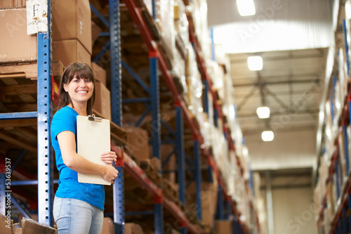 Photo: Female Worker In Distribution Warehouse Female Worker In Distribution Warehouse