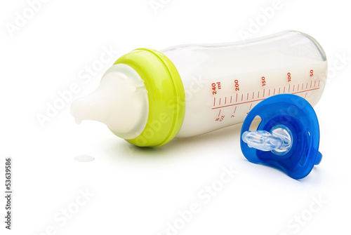 Photo: baby bottle and blue pacifier with clipping path baby bottle and blue pacifier with clipping path