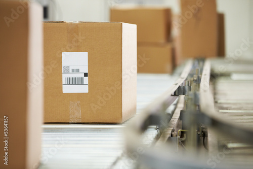 Photo: Goods On Conveyor Belt In Distribution Warehouse Goods On Conveyor Belt In Distribution Warehouse