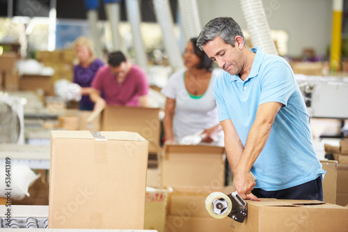 Photo: Workers In Warehouse Preparing Goods For Dispatch Workers In Warehouse Preparing Goods For Dispatch