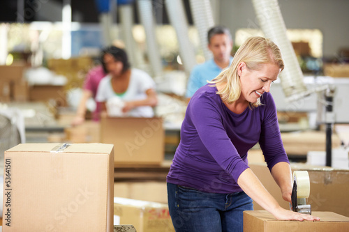 Photo: Workers In Warehouse Preparing Goods For Dispatch Workers In Warehouse Preparing Goods For Dispatch