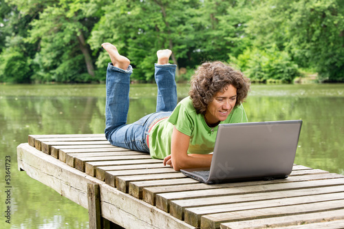 Photo: Frau mit Notebook am idyllischen Teich - Home Office Frau mit Notebook am idyllischen Teich - Home Office