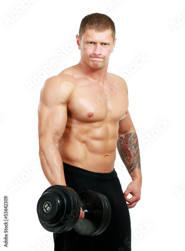 Photo: Handsome muscular man working out with dumbbells Handsome muscular man working out with dumbbells
