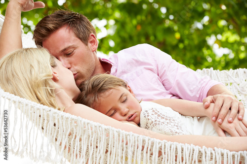 Photo: Family Relaxing In Beach Hammock With Sleeping Daughter Family Relaxing In Beach Hammock With Sleeping Daughter