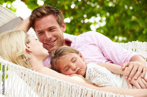 Photo: Family Relaxing In Beach Hammock With Sleeping Daughter Family Relaxing In Beach Hammock With Sleeping Daughter