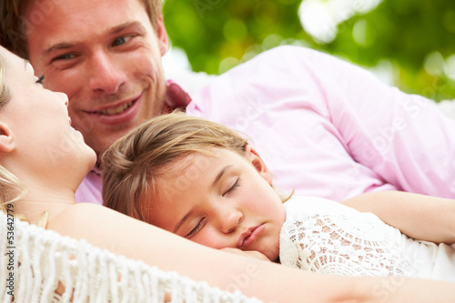 Photo: Family Relaxing In Beach Hammock With Sleeping Daughter Family Relaxing In Beach Hammock With Sleeping Daughter