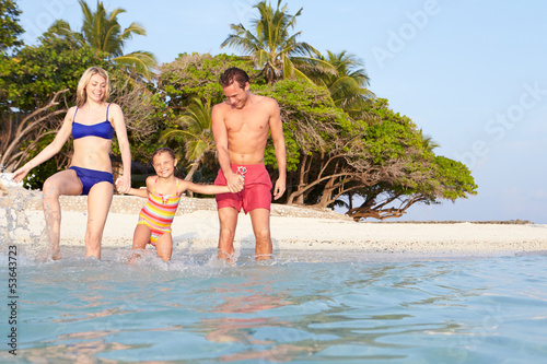 Photo: Family Splashing In The Sea On Tropical Beach Holiday Family Splashing In The Sea On Tropical Beach Holiday