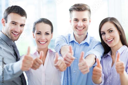 Photo: Business team with thumbs up Business team with thumbs up