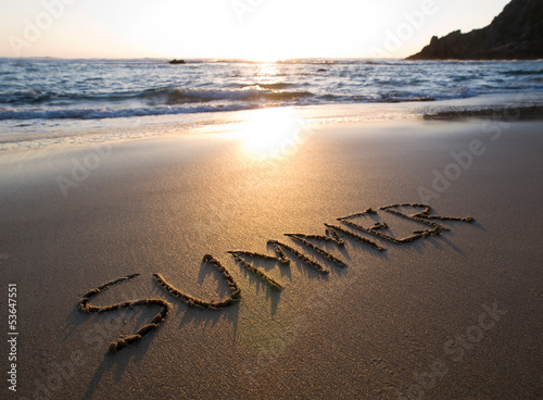 Photo: Word summer written in the sand Word summer written in the sand