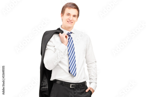 Photo: Young businessman posing with a coat over shoulder Young businessman posing with a coat over shoulder