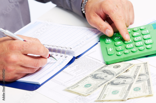 Photo: Hands of businessman with calculator. Hands of businessman with calculator.