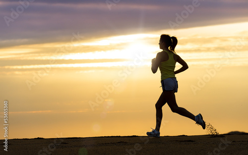 Photo: Athlete running at sunset on beach Athlete running at sunset on beach