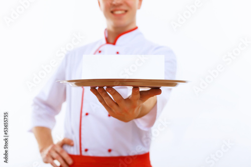 Photo: Cook holding an empty tray Cook holding an empty tray