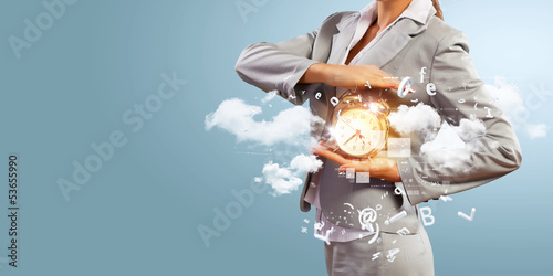 Photo: Business man holding alarmclock Business man holding alarmclock