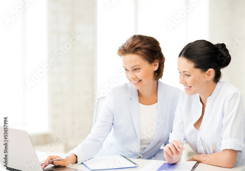 Photo: businesswomen working with laptop in office businesswomen working with laptop in office