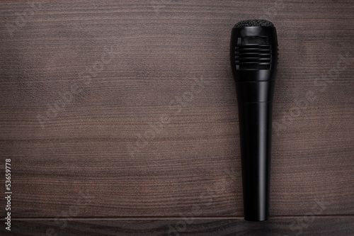 Photo: black mic on the wooden table black mic on the wooden table