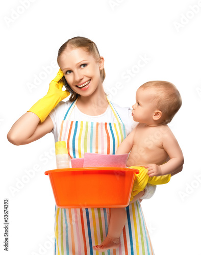 Photo: young happy mother is a housewife with a baby does homework and young happy mother is a housewife with a baby does homework and