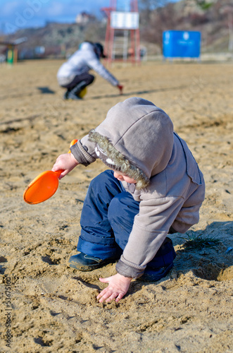 Photo: Cute child playing on the beach Cute child playing on the beach