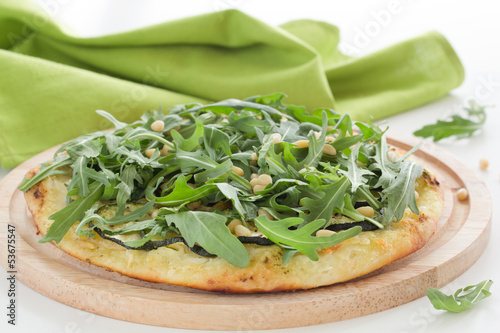 Photo: Pizza with mozzarella cheese, arugula and nuts. Pizza with mozzarella cheese, arugula and nuts.