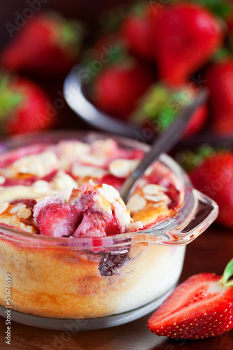 Photo: Clafoutis with strawberries and almonds, selective focus Clafoutis with strawberries and almonds, selective focus