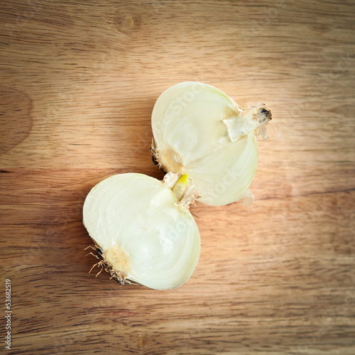 Photo: Cut onion on a wooden background Cut onion on a wooden background