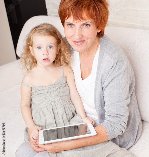 Photo: Family wiht tablet computer at sofa Family wiht tablet computer at sofa