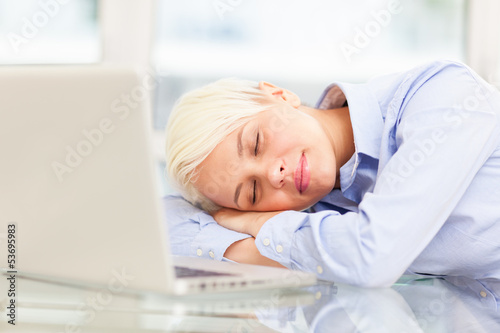 Photo: Exhausted businesswoman sleeps on notebook Exhausted businesswoman sleeps on notebook