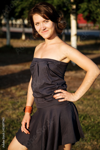 Photo: portrait of the girl in the park at sunny day portrait of the girl in the park at sunny day