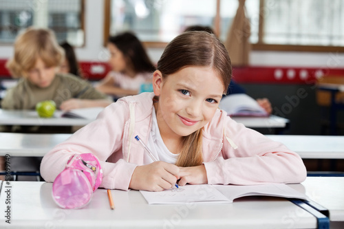 Photo: Portrait Of Schoolgirl Drawing In Book Portrait Of Schoolgirl Drawing In Book