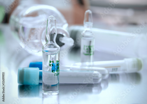 Photo: ampule against the tubes and other medical objects ampule against the tubes and other medical objects