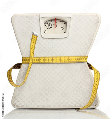 Photo: Weight scale with a measuring tape over white Weight scale with a measuring tape over white