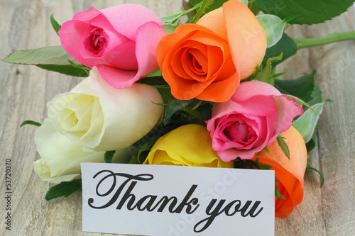 Photo: Thank you note with yellow bouquet on white wooden surface Thank you note with yellow bouquet on white wooden surface
