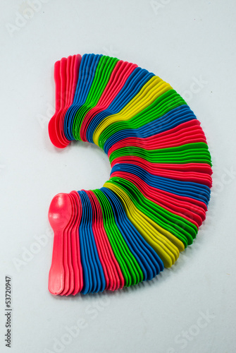Photo: Semicircle Set of Colored Plastic Spoons, Isolated top view Semicircle Set of Colored Plastic Spoons, Isolated top view