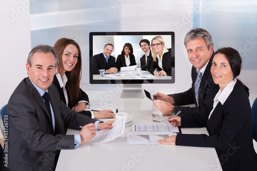 Photo: Group Of Businesspeople In Video Conference Group Of Businesspeople In Video Conference