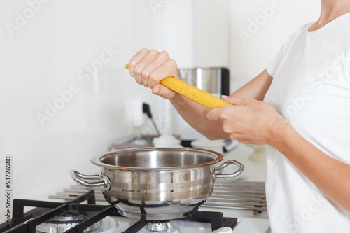 Photo: Young woman with spaghetti cooking Italian cousine Young woman with spaghetti cooking Italian cousine