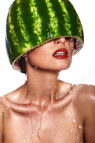 Photo: model with water-melon on head with water drops with red lips model with water-melon on head with water drops with red lips