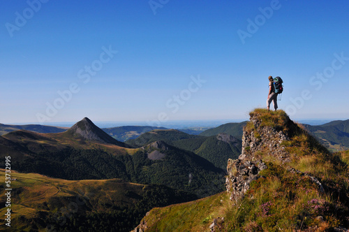 Photo: hiker on top of a rock looking far away hiker on top of a rock looking far away
