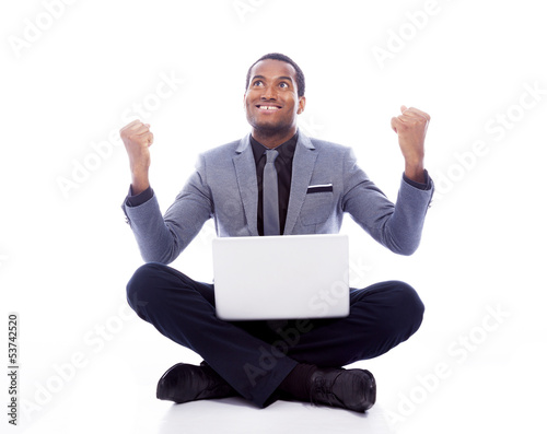 Photo: Successful business man with laptop and raised arms - isolated o Successful business man with laptop and raised arms - isolated o