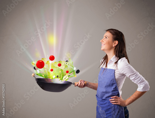 Photo: Young woman cooking fresh vegetables Young woman cooking fresh vegetables