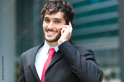 Photo: Handsome businessman talking on the cellphone Handsome businessman talking on the cellphone