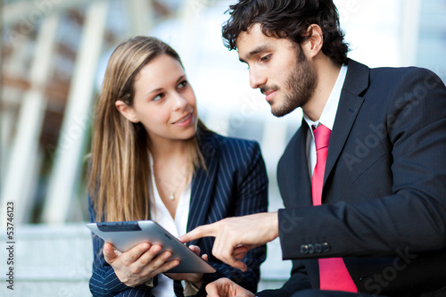 Photo: Portrait of two business people at work Portrait of two business people at work